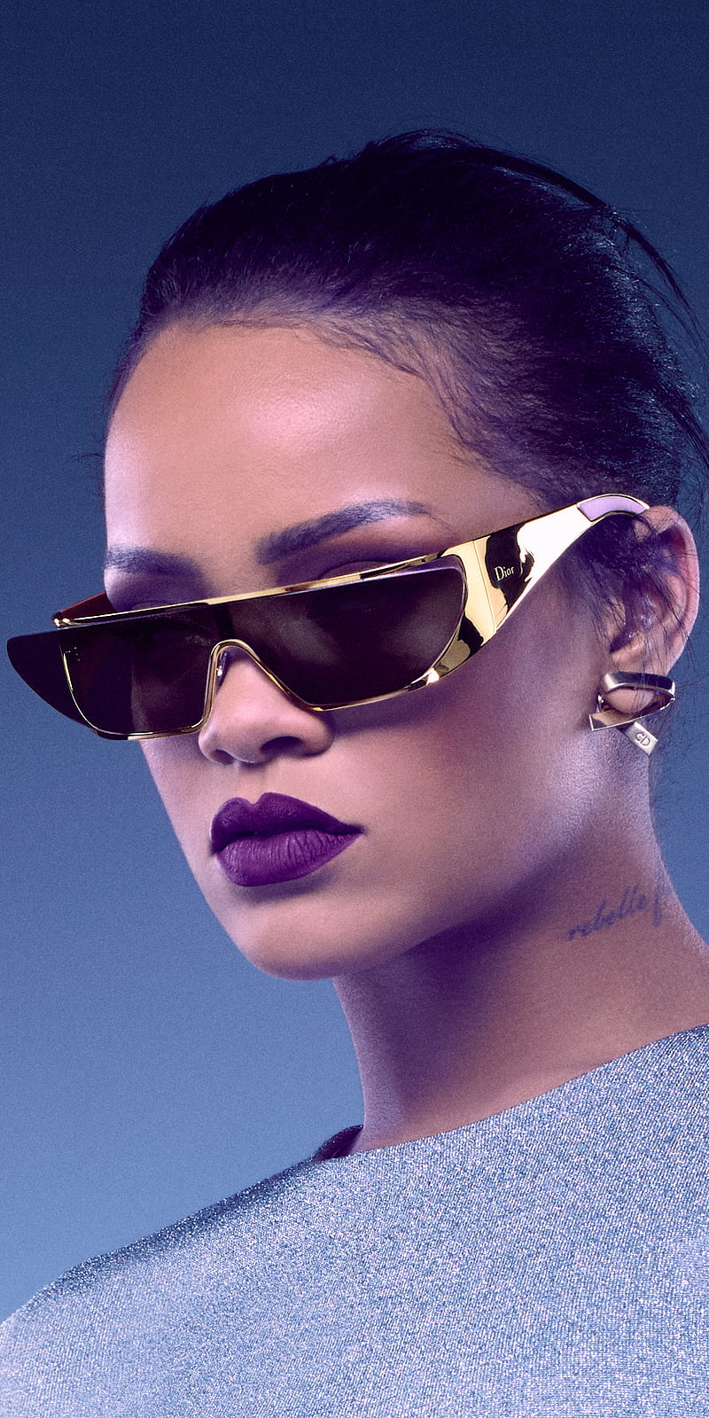 A woman with purple lips and sunglasses - Rihanna