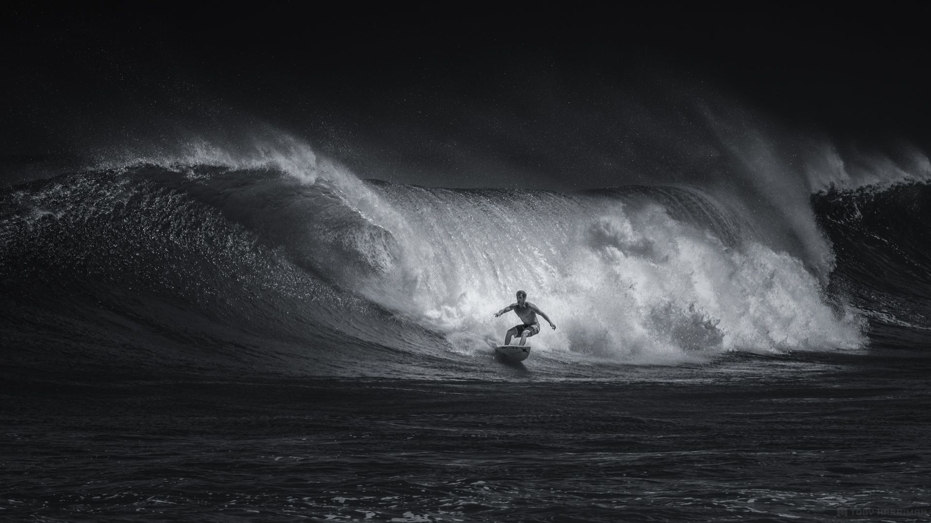 A man riding on top of an ocean wave - Surf