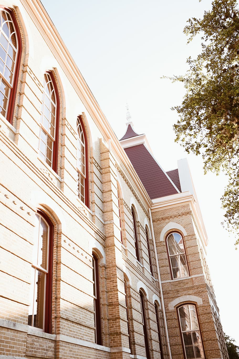 A large building with many windows and a clock tower. - Texas