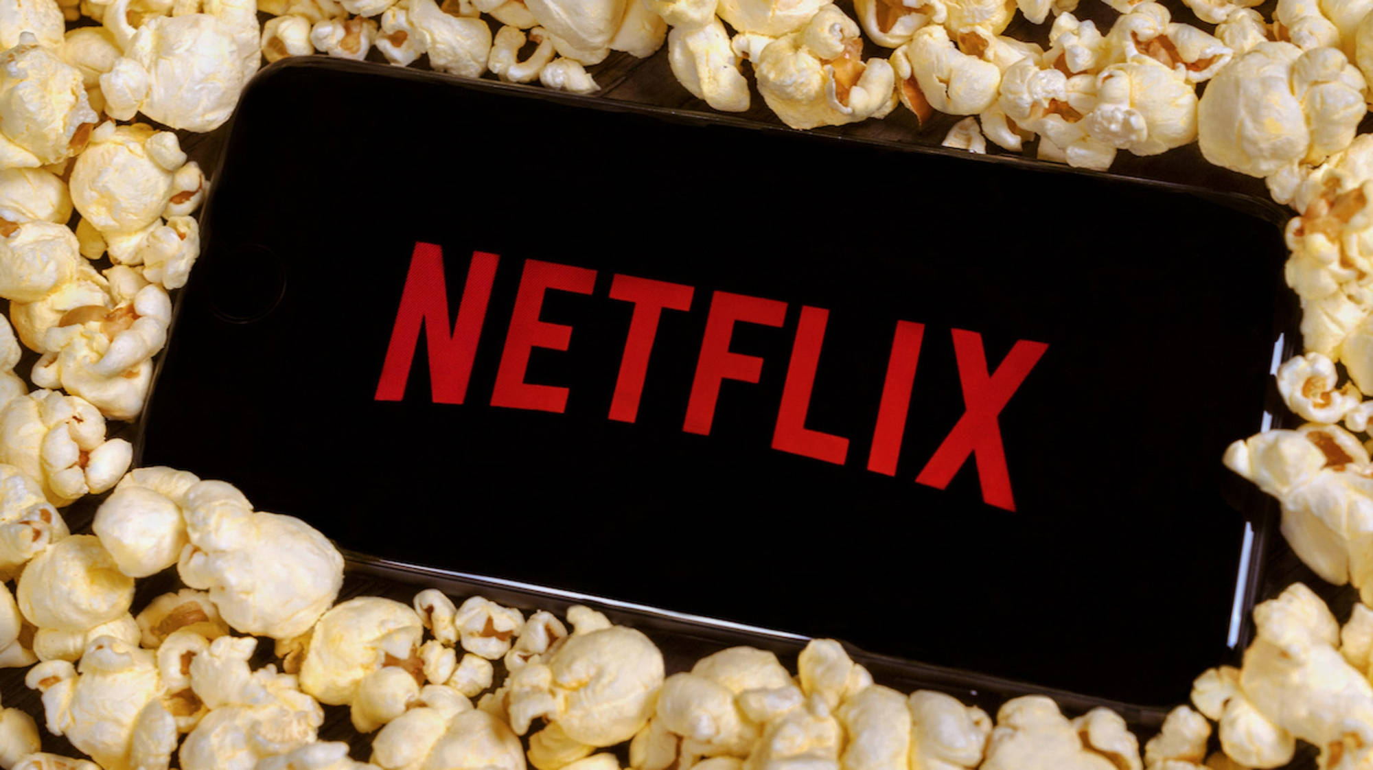 Netflix logo is seen on a smartphone surrounded by popcorn in this illustration photo taken on October 27, 2020. - Netflix, popcorn