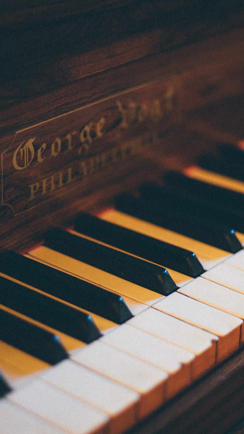 A close up of an old piano - Piano