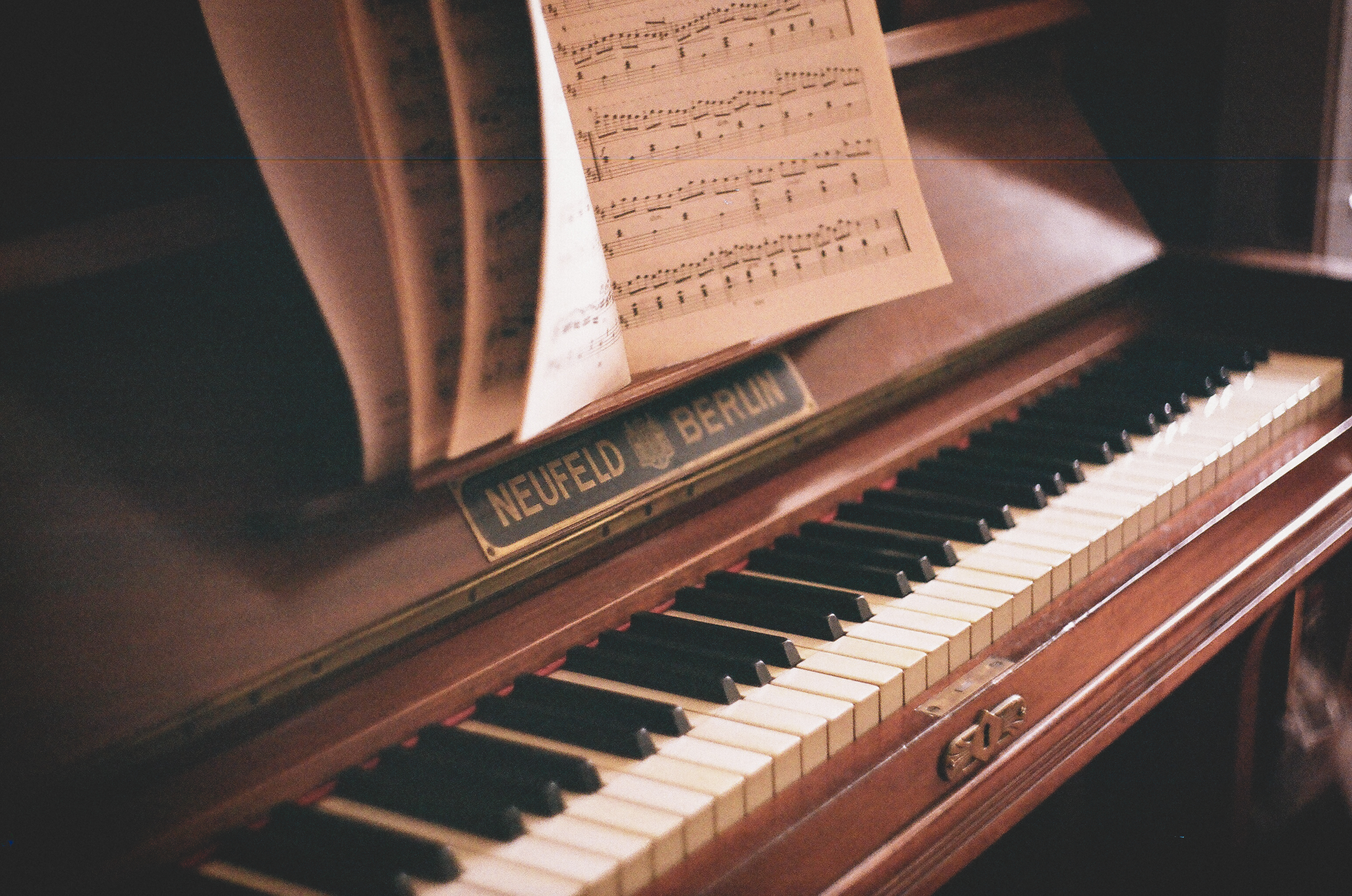 A piano with sheet music on the keys - Piano