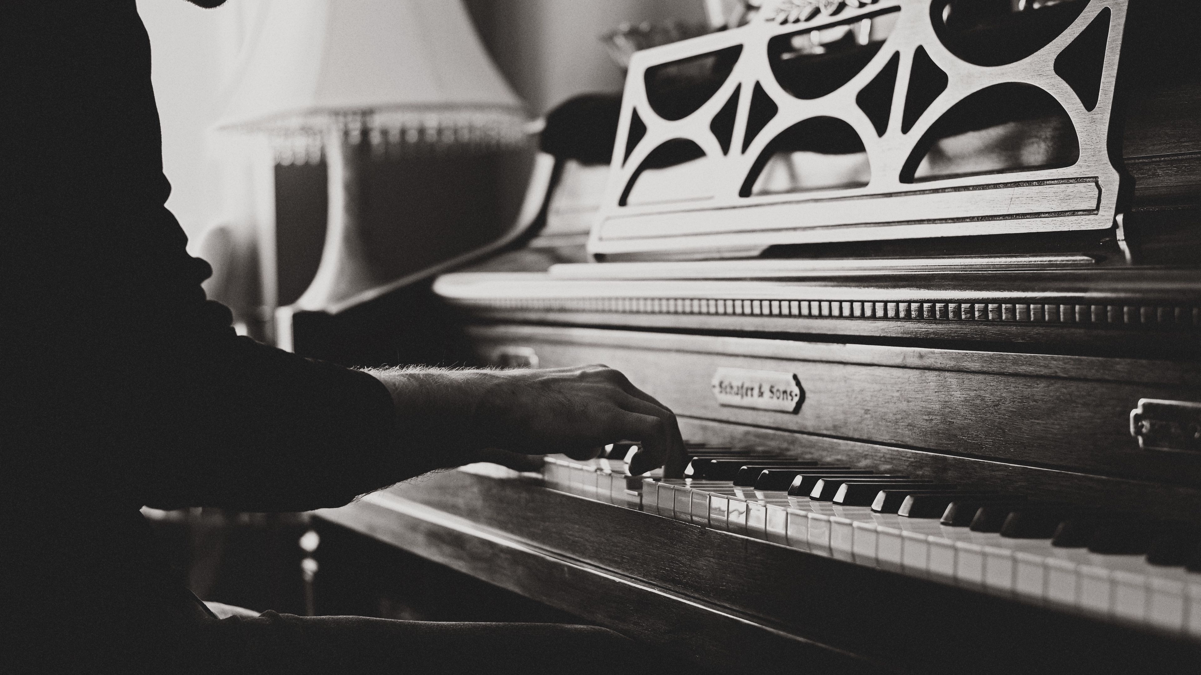 A man's hand playing a piano - Piano