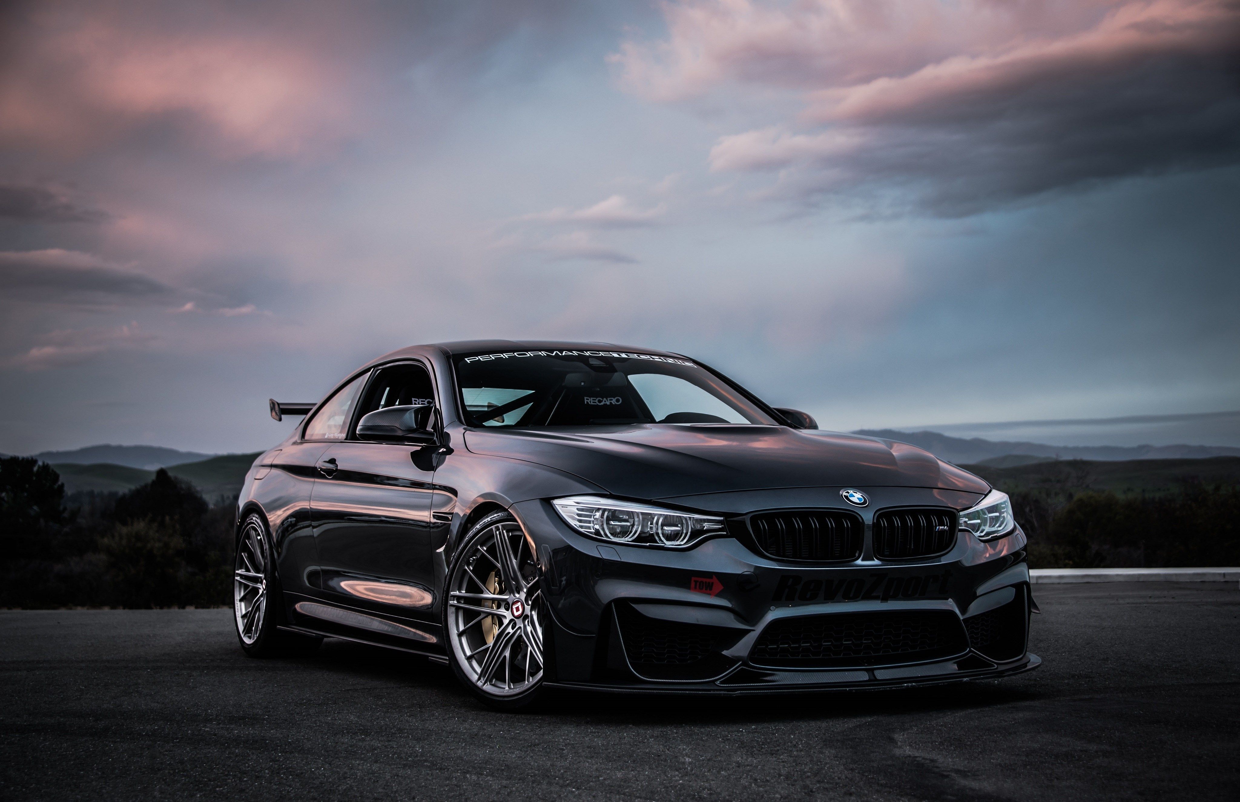 A black bmw car parked on the street - BMW