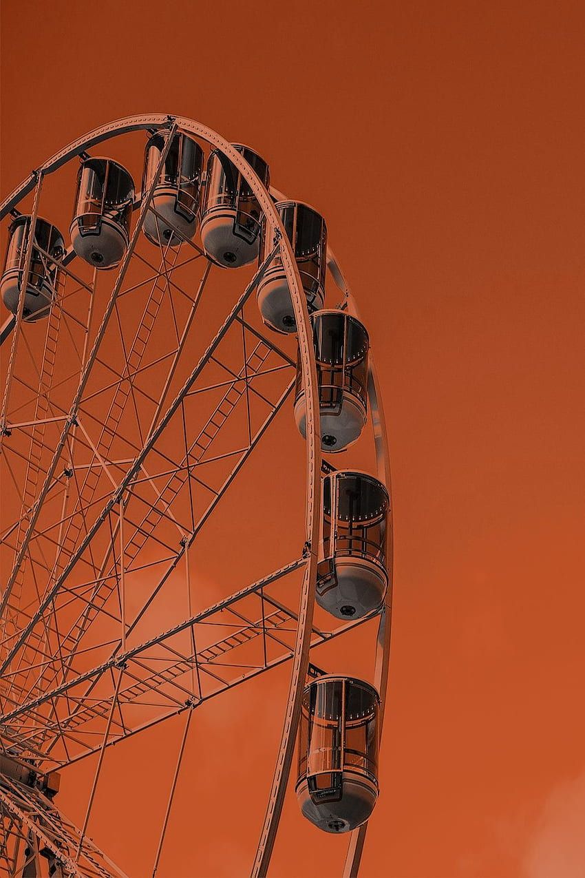 A ferris wheel is in the sky - Dark orange