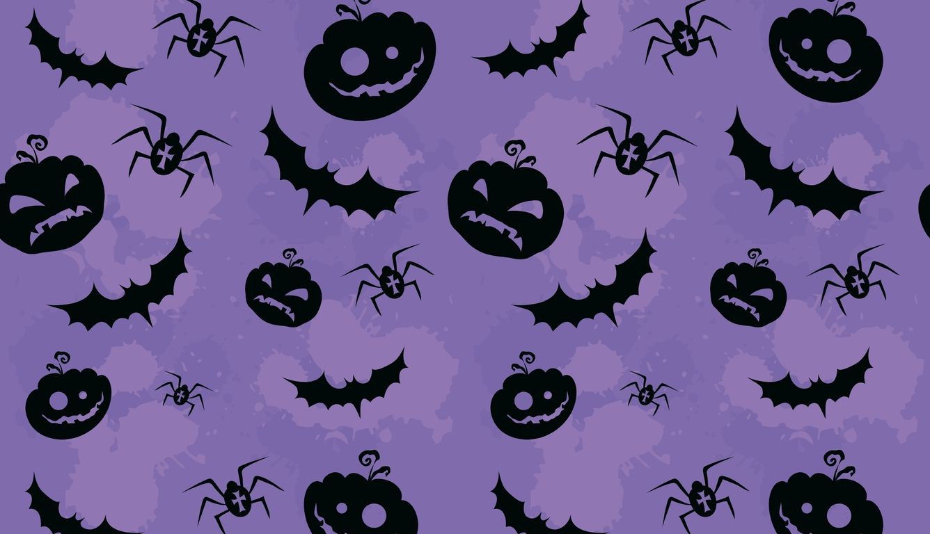 A purple background with black bats, spiders and pumpkins - Halloween desktop