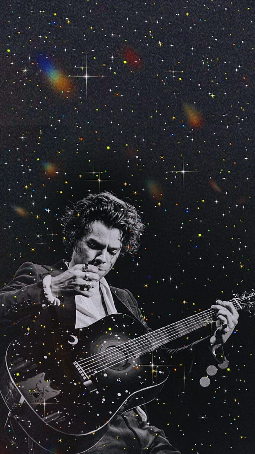 A man playing guitar with stars in the background - Harry Styles