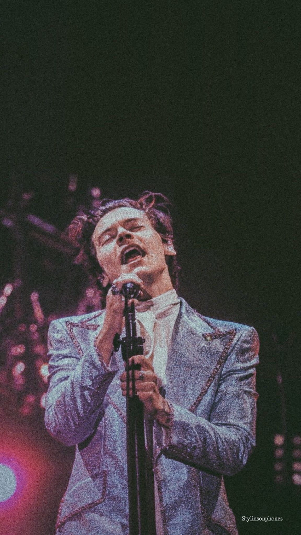 Harry Styles singing on stage in a silver suit - Harry Styles