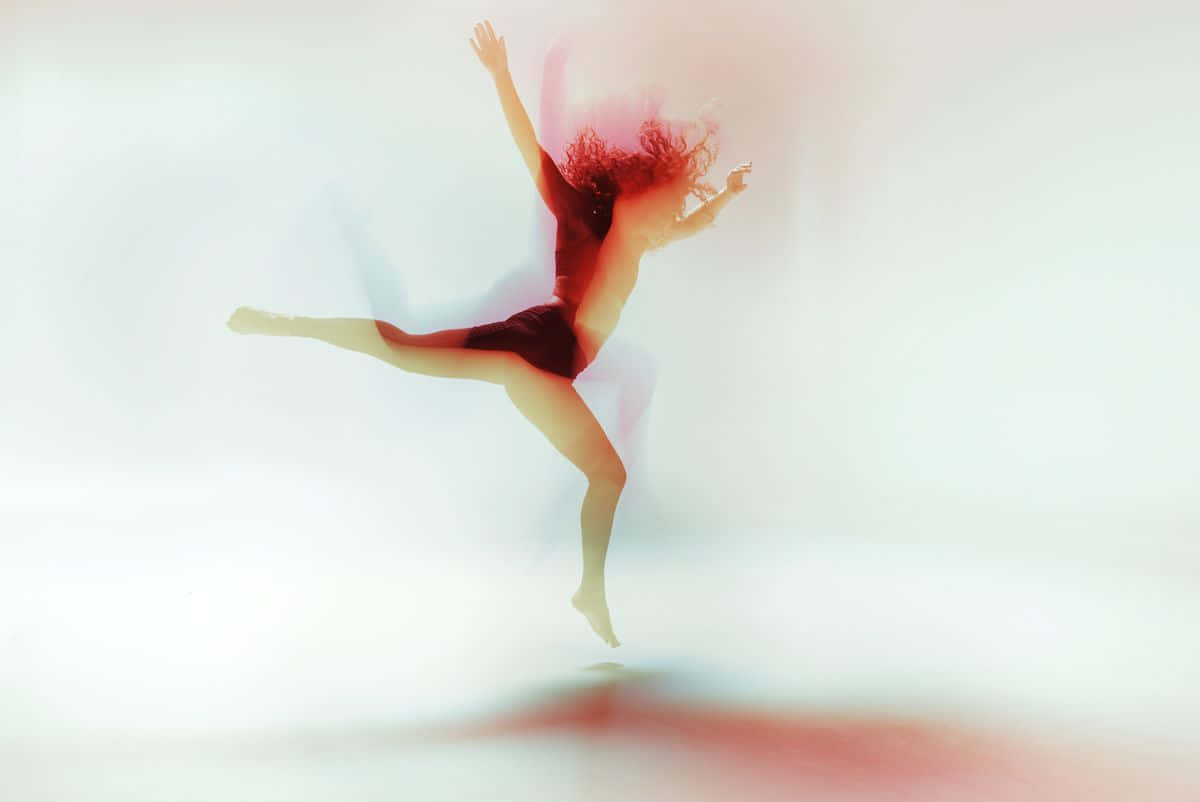 A woman in red dancing on white background - Gymnastics