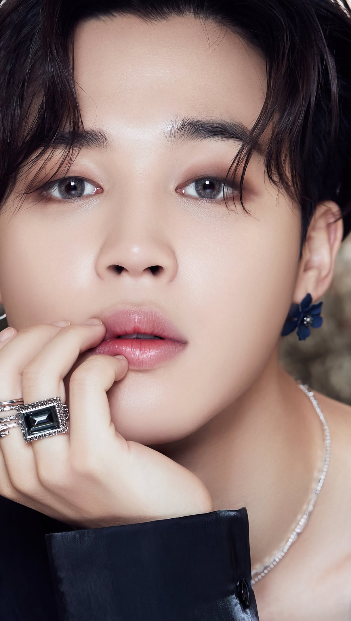 A young man with black hair and rings - Jimin