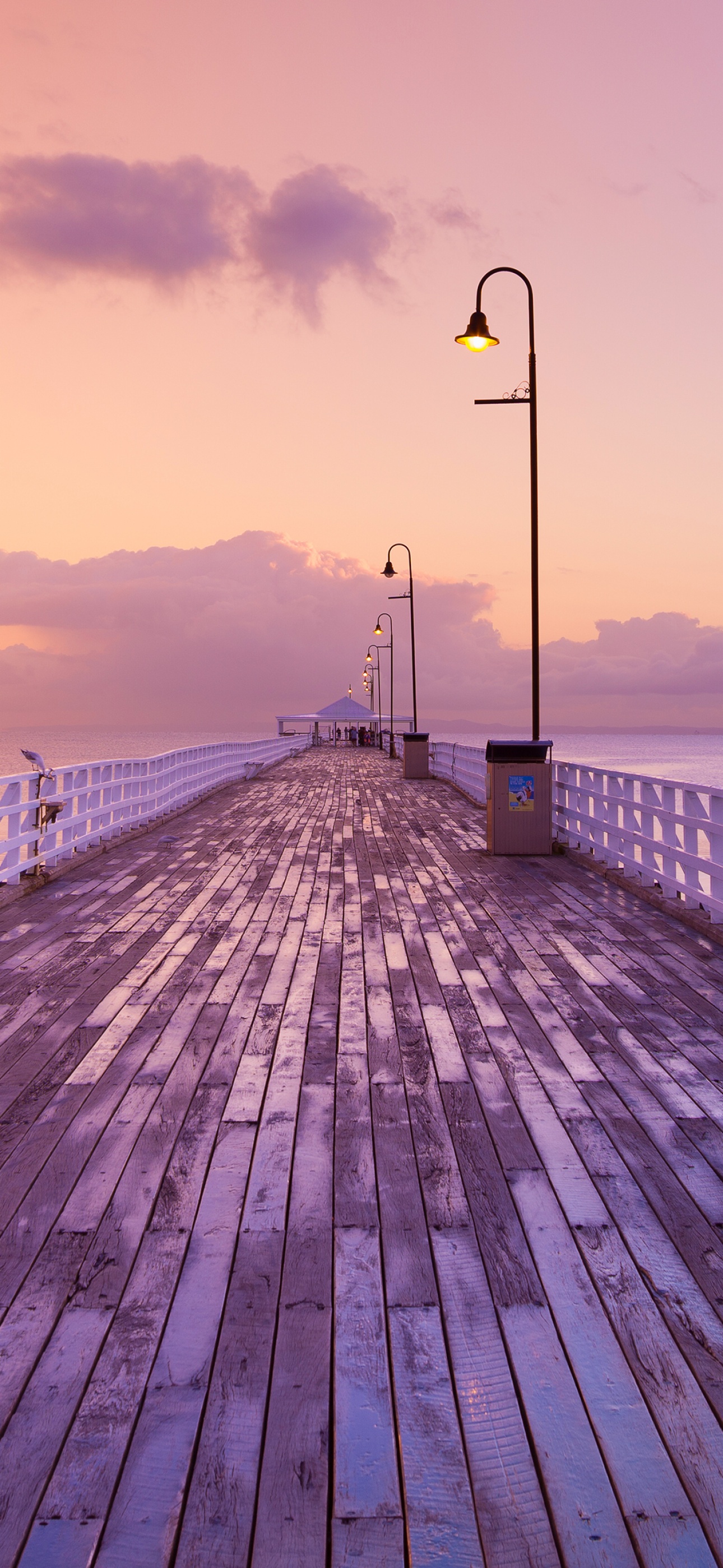 A wooden pier with lights and water - Sunrise