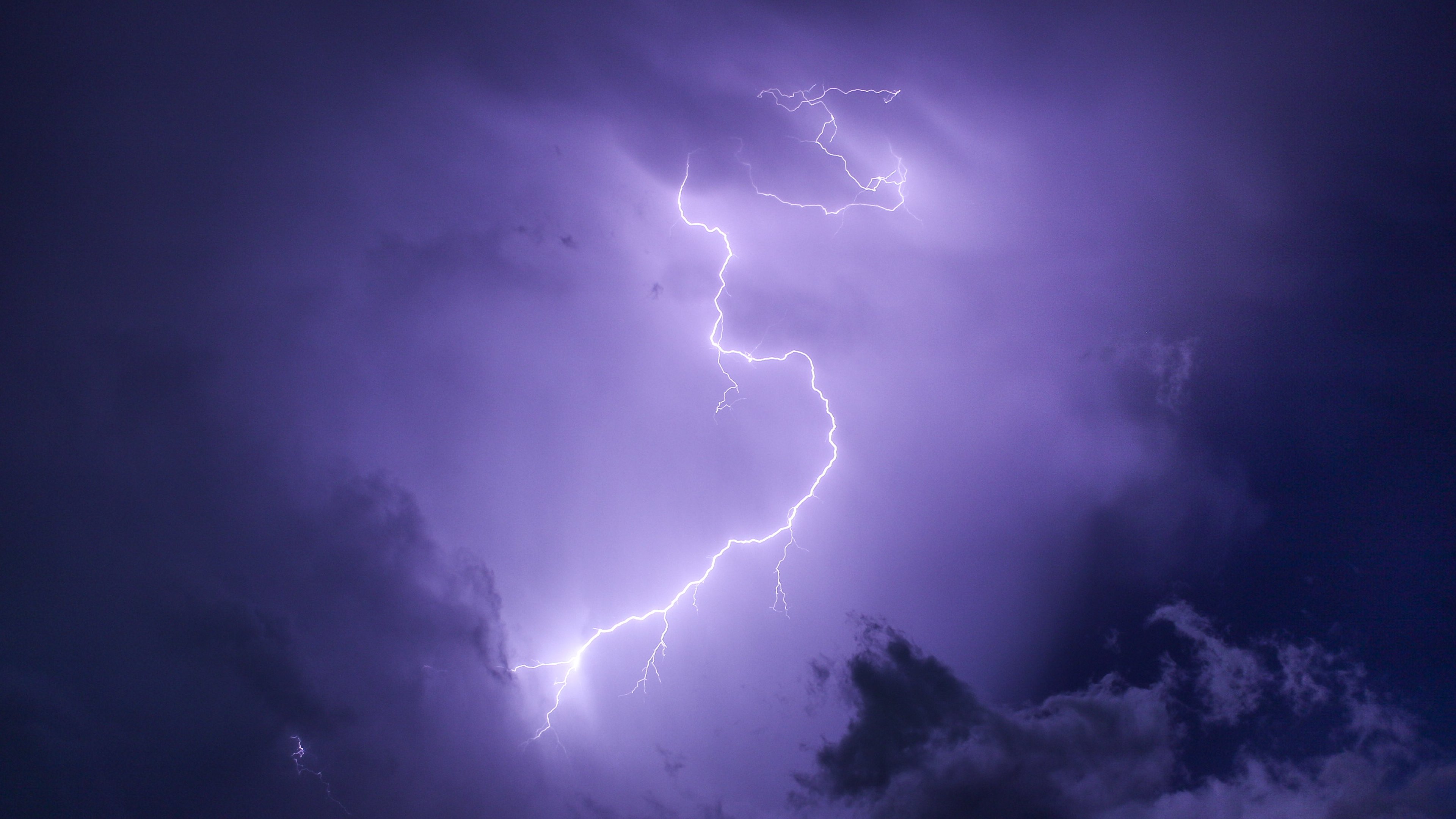 A lightning bolt strikes the sky in this photo - Lightning