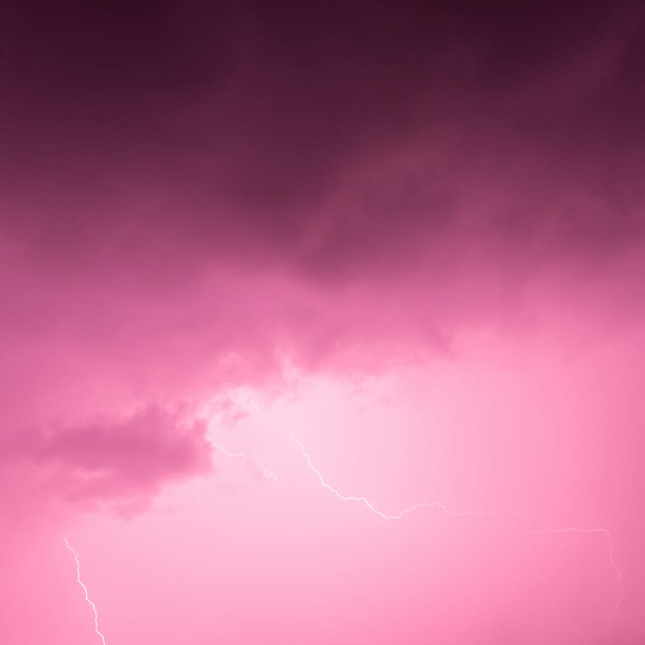 A pink sky with lightning in the background - Lightning