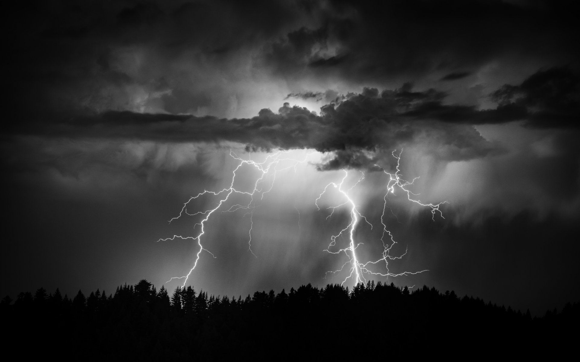 A black and white photo of lightning in the sky - Lightning