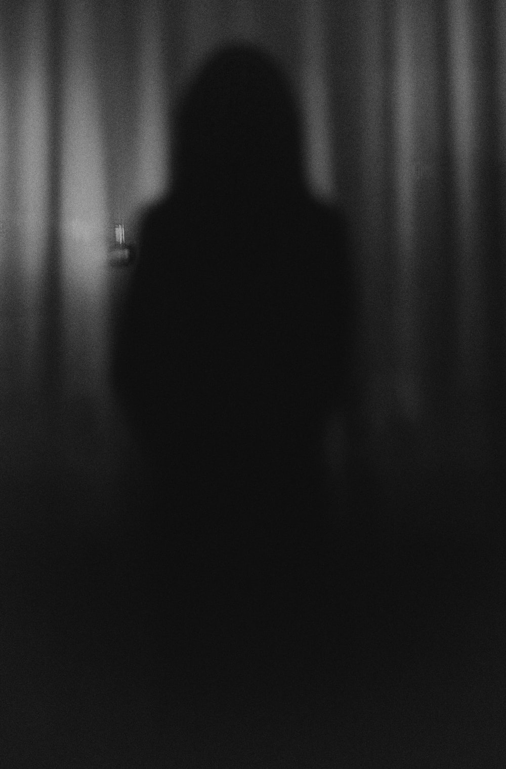 A person standing in front of curtains - Vampire