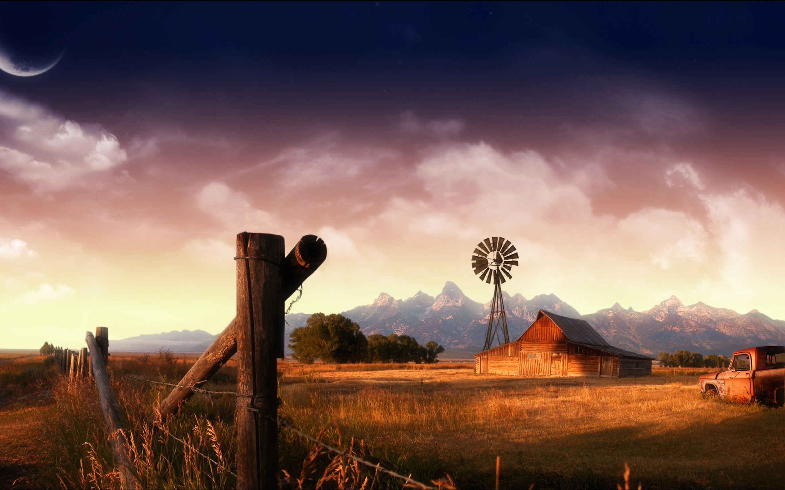 A fence post in front of a barn and windmill. - Western