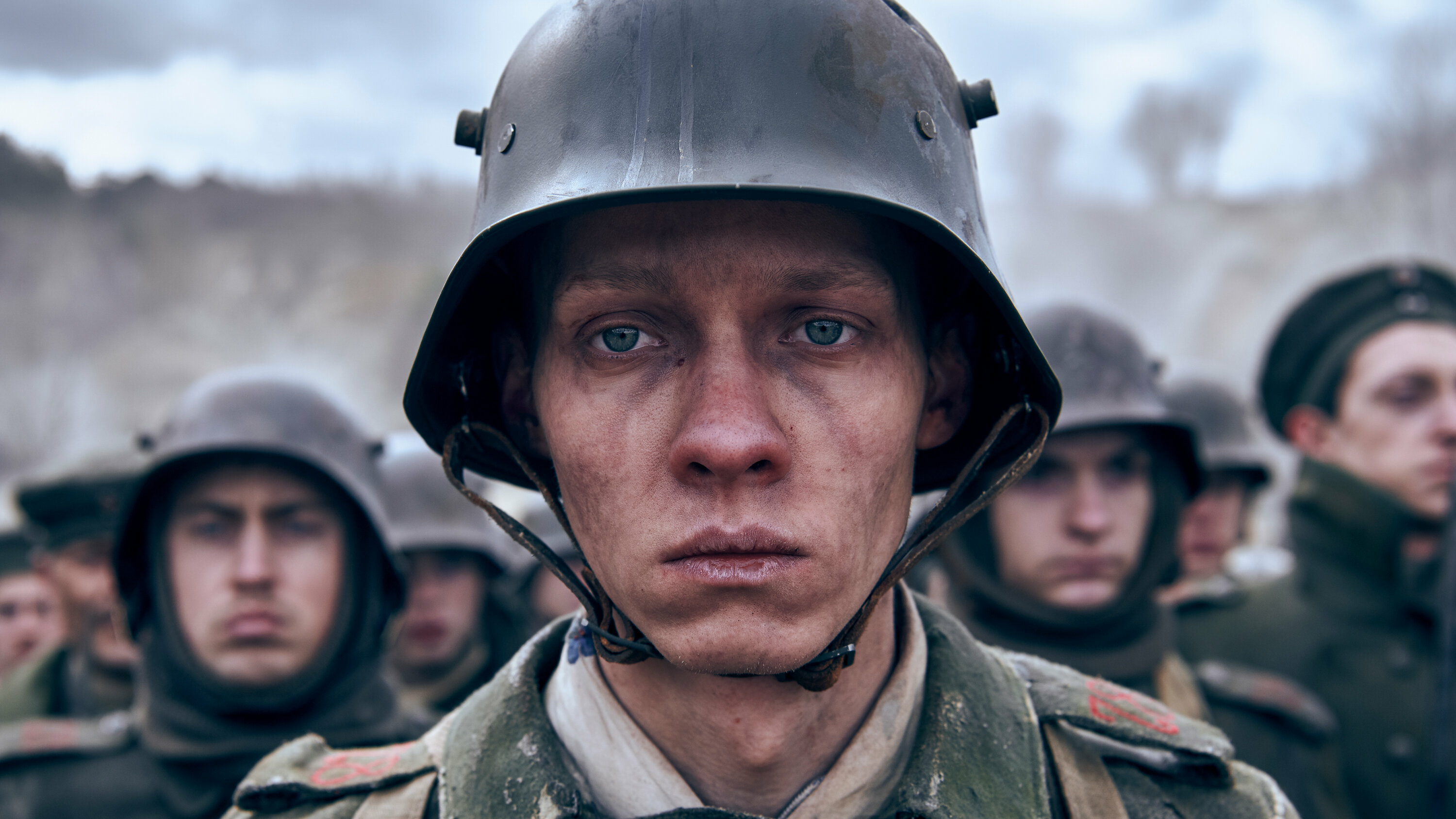 A man in uniform with helmet and other soldiers - Western