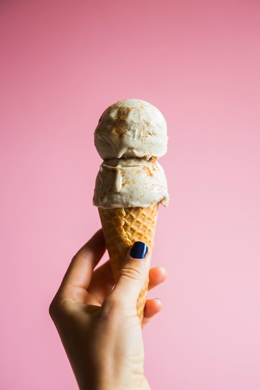 A person holding two ice cream cones - Ice cream