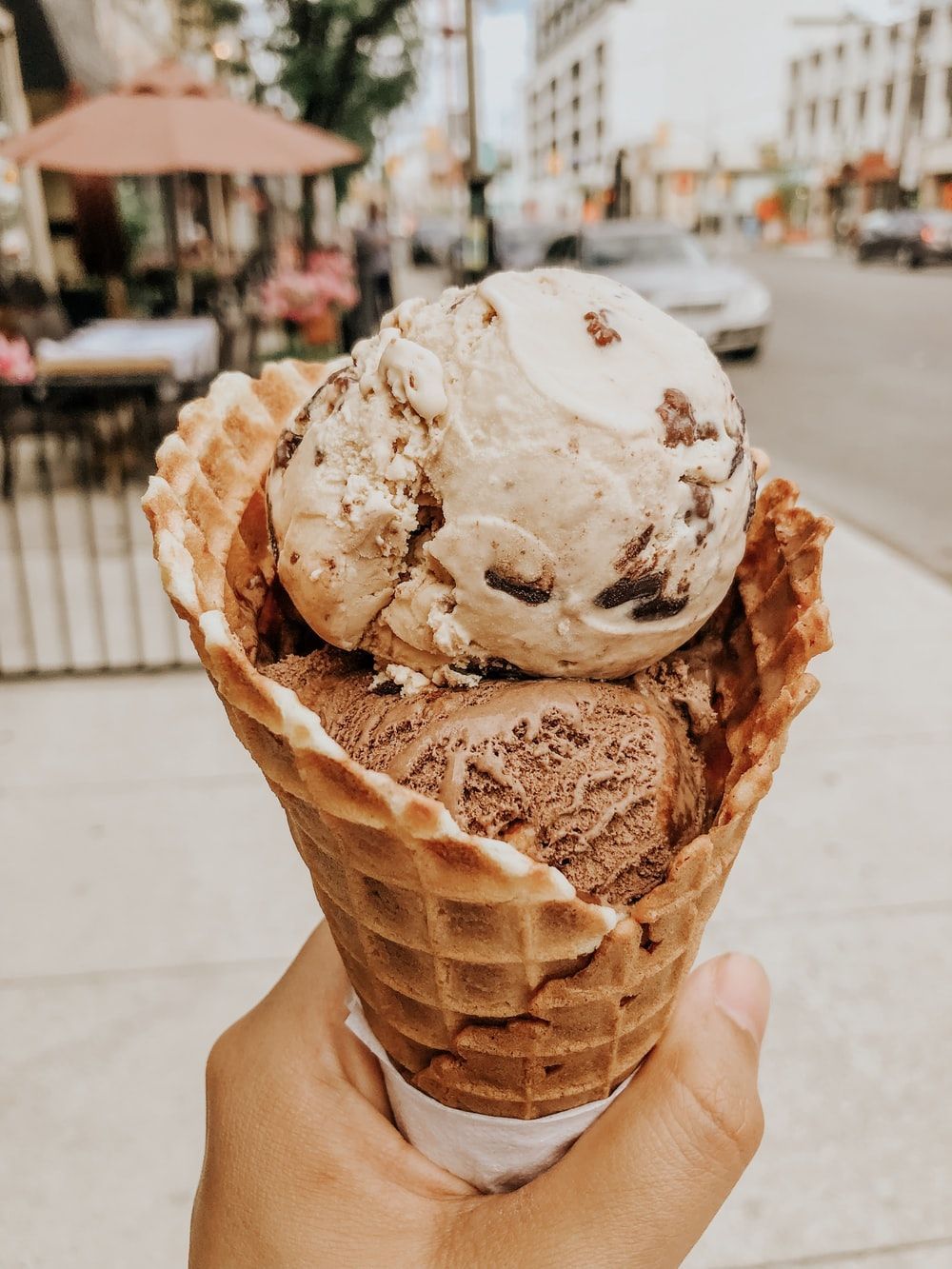 A person holding an ice cream cone in their hand - Ice cream