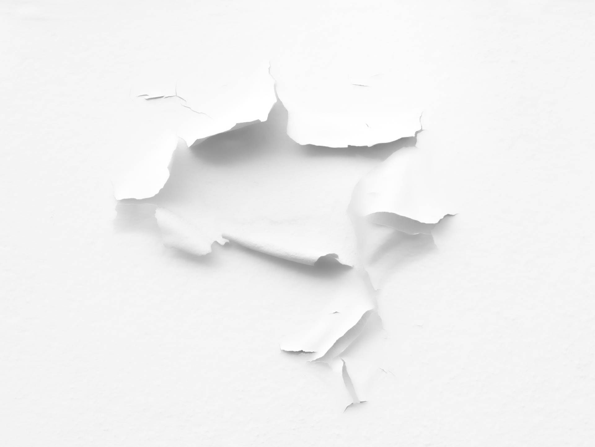 A hole in a piece of white paper - White