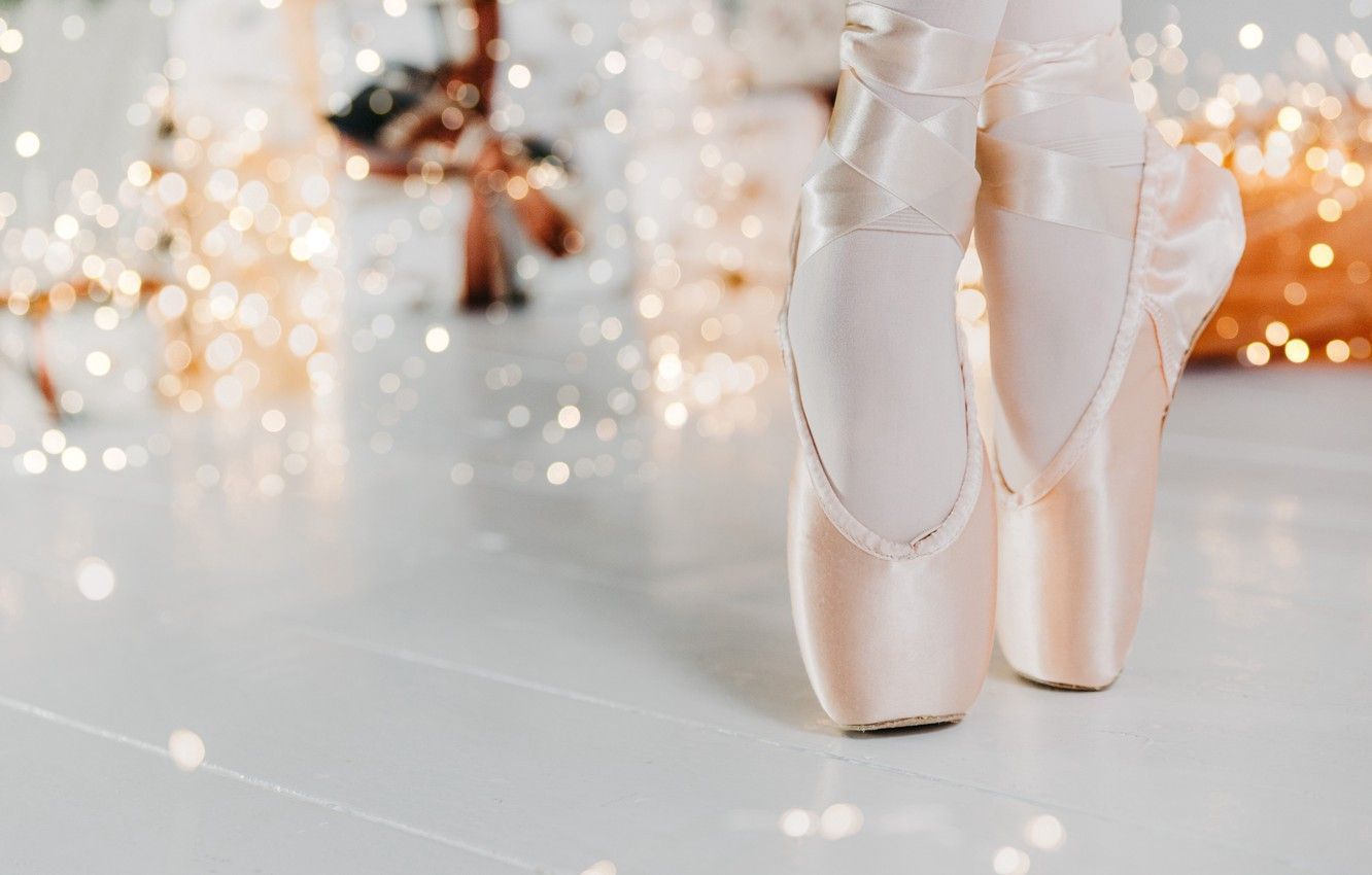 A pair of pointe shoes with a bokeh background - Ballet