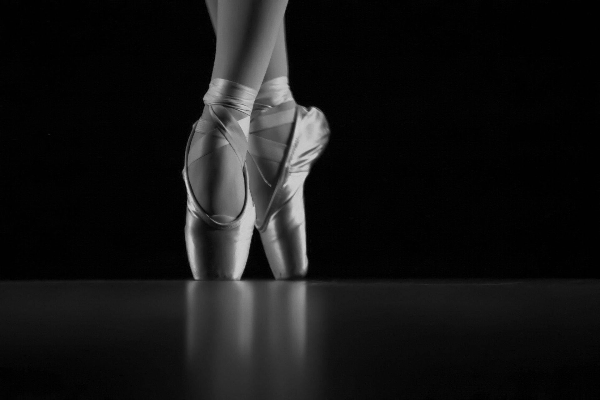 A black and white photo of a ballerina's feet in pointe shoes. - Ballet