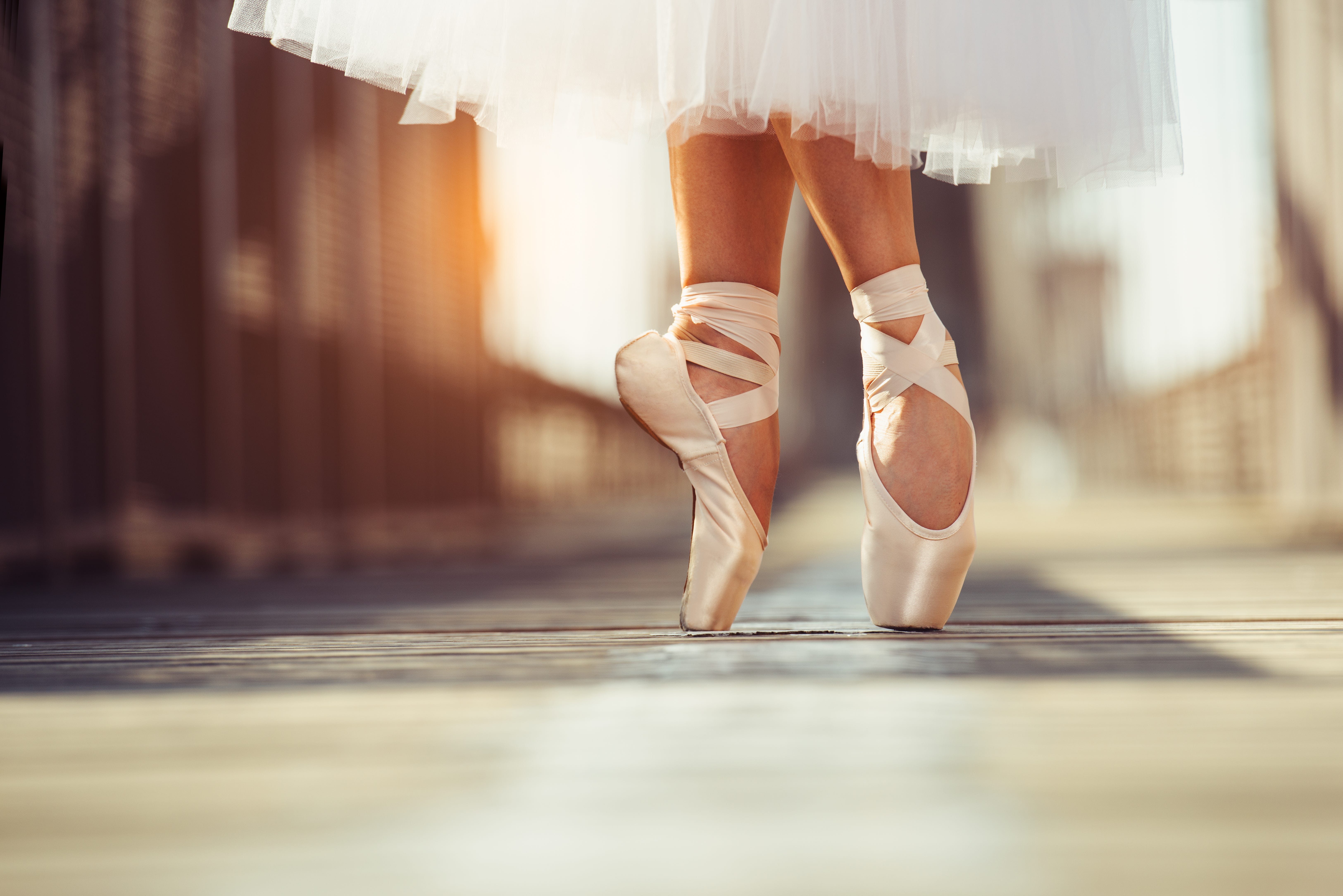 A woman in ballet shoes standing on the bridge - Ballet