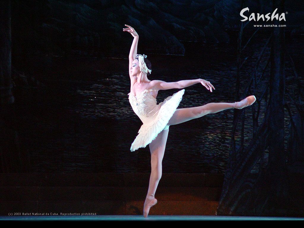Ballerina in white tutu dancing on stage in front of a lake - Ballet
