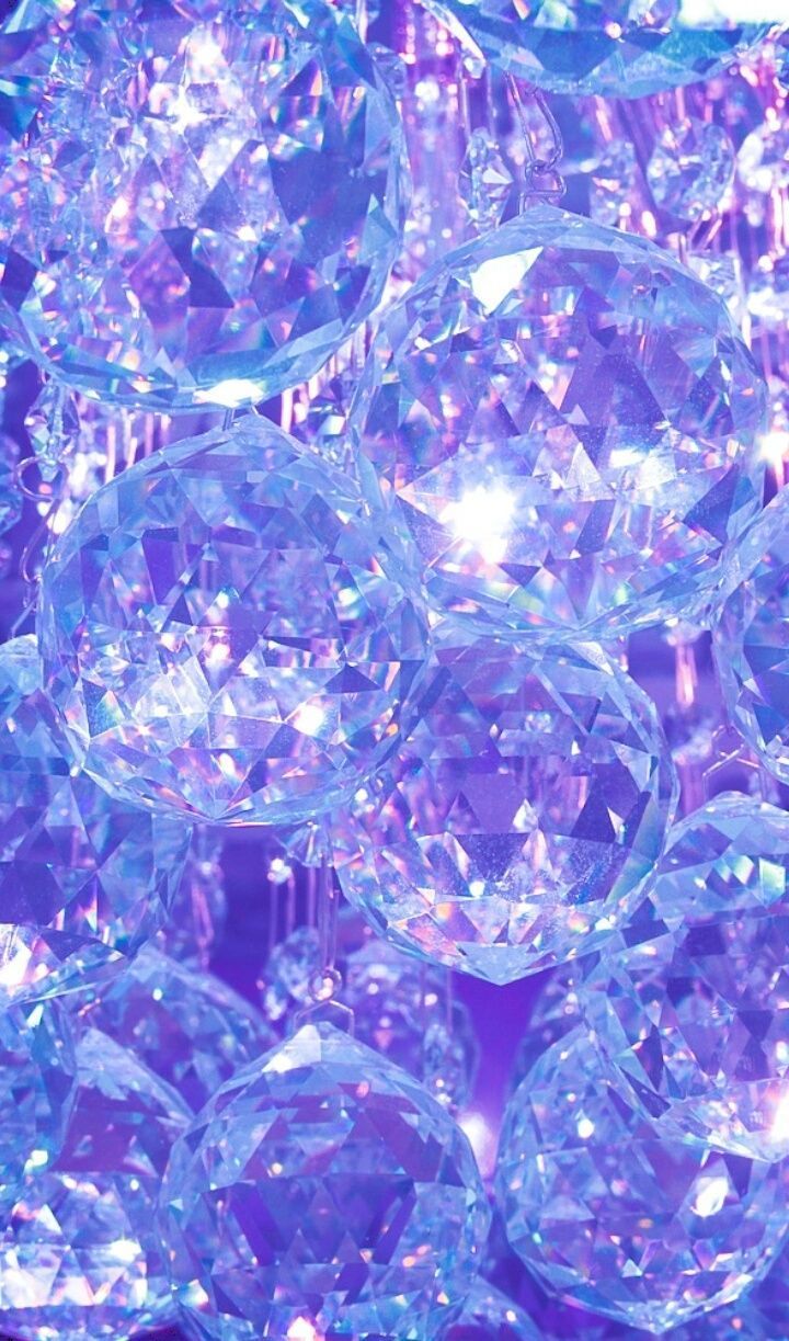 A close up of a purple chandelier with lots of crystals - Diamond