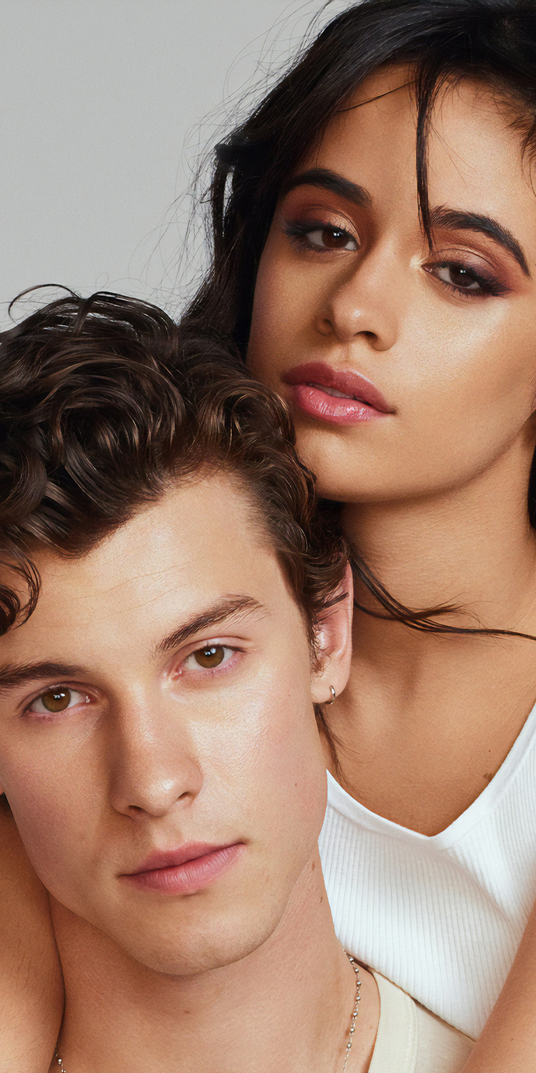 A man and woman are posing for the camera - Shawn Mendes
