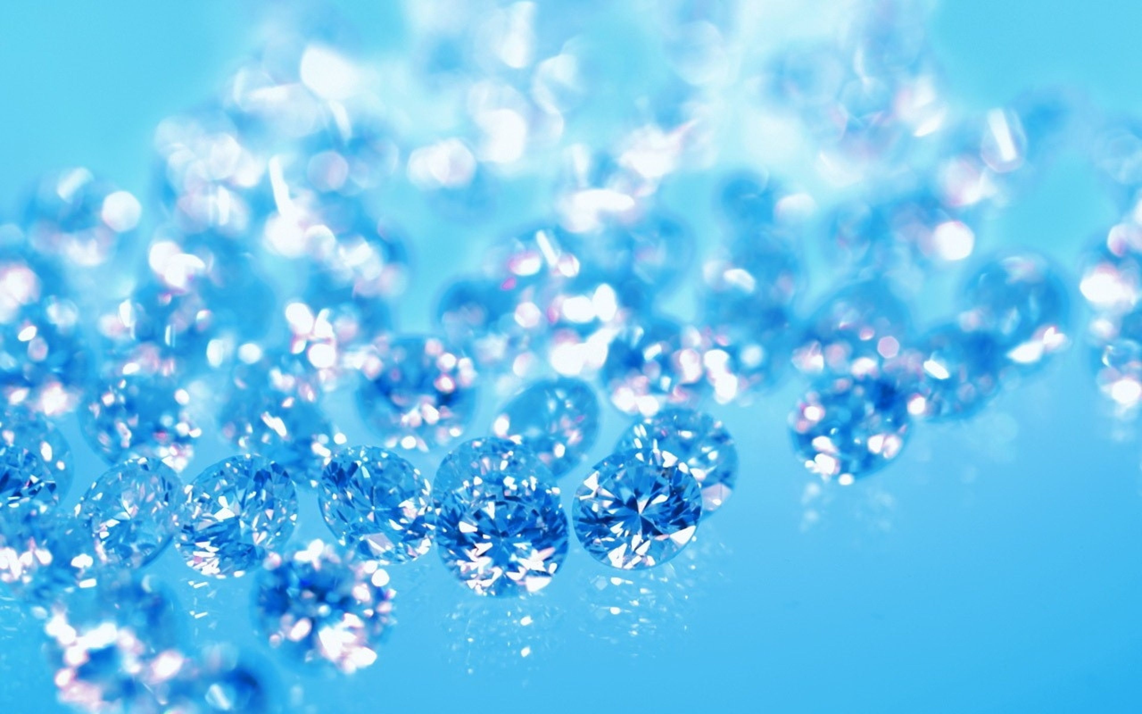 A close up of a pile of diamonds on a blue background - Diamond