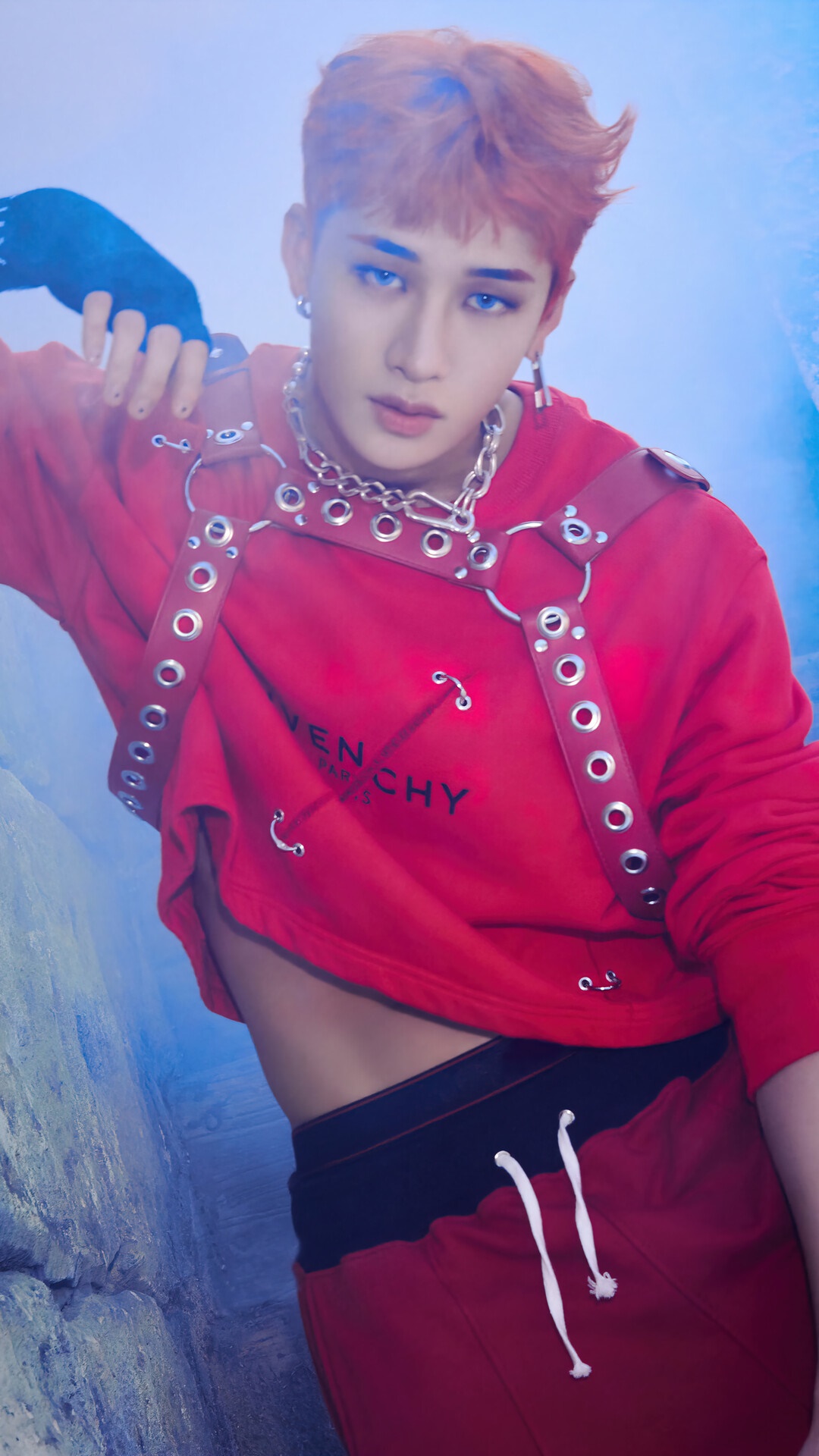 Mark wearing a red Givenchy hoodie and red pants with a harness - Bang Chan
