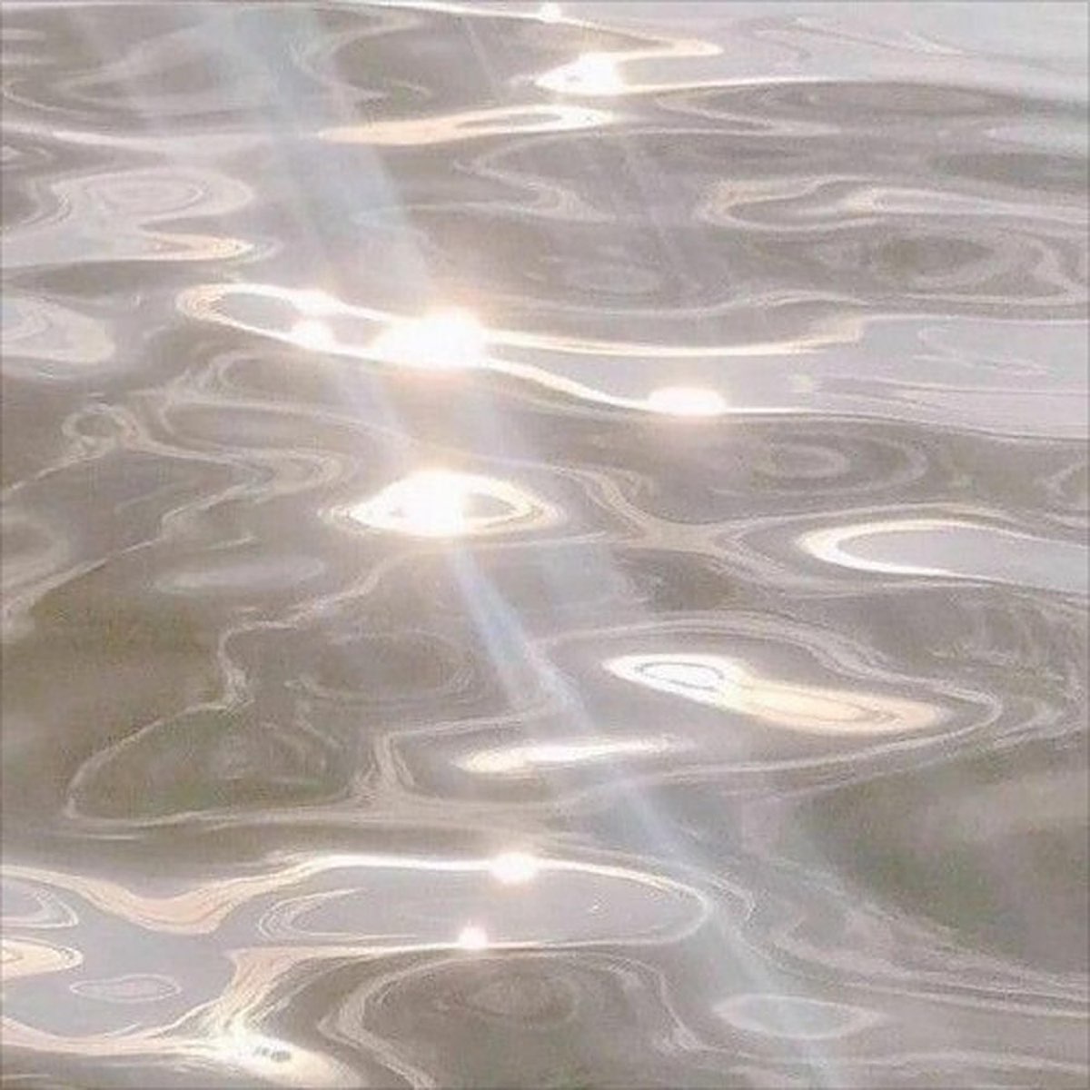 A close up of water with sunlight reflecting off it - Bling