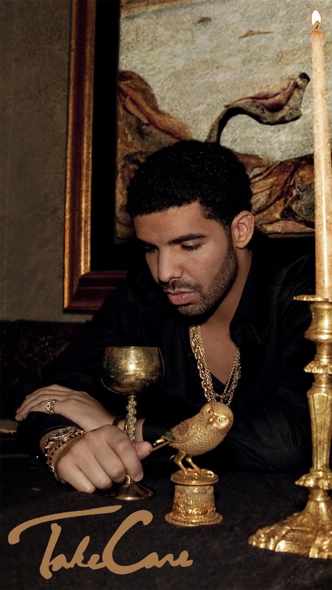 IPhone wallpaper of Drake sitting at a table with a wine glass and a candle. - Drake