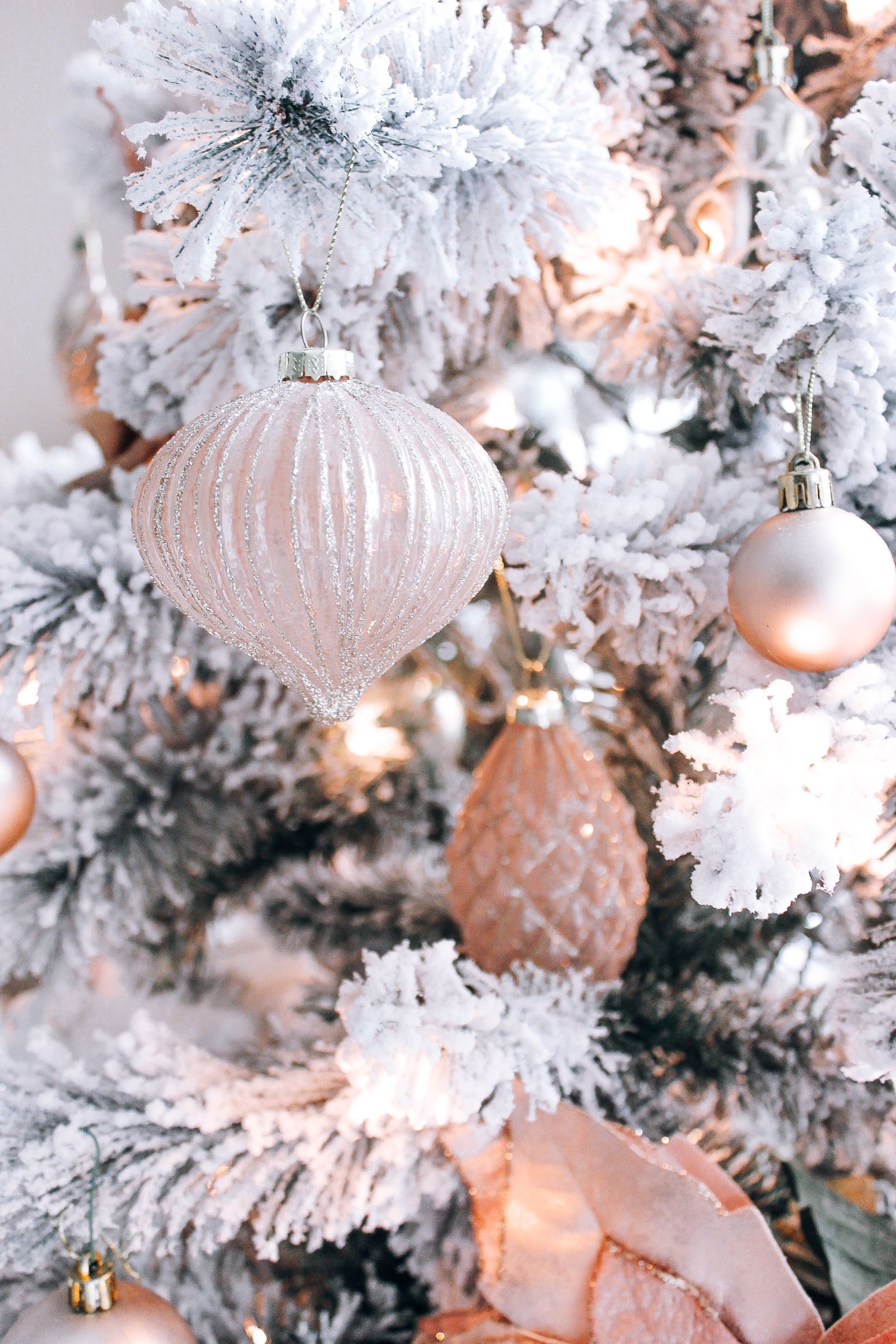 A christmas tree with pink ornaments and snow - White Christmas