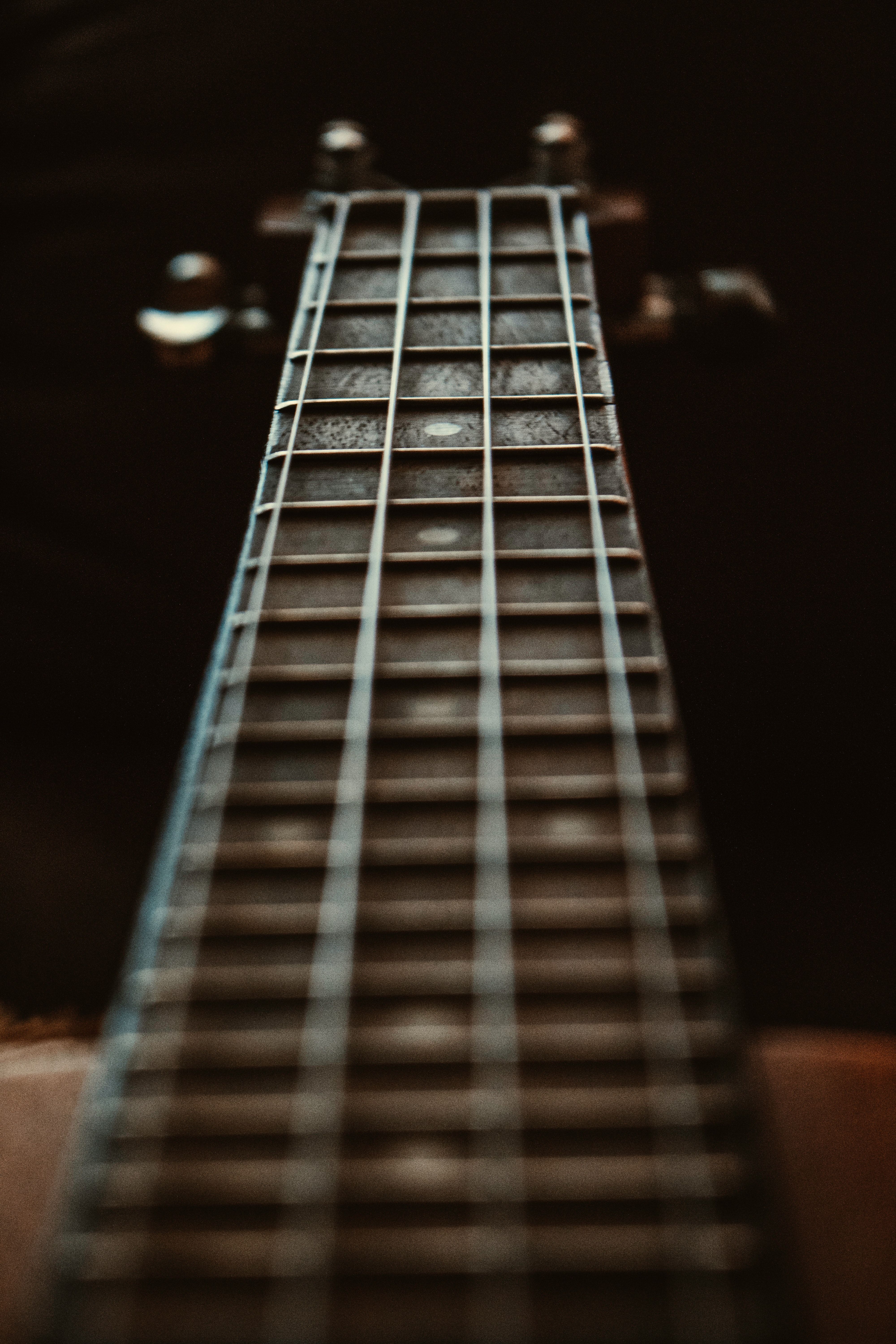 A close up of the neck of a guitar. - Guitar