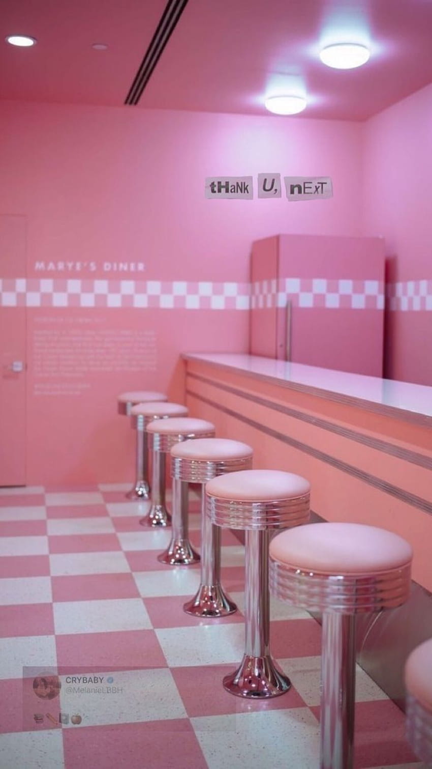 A pink room with checkered floors and stools - Melanie Martinez