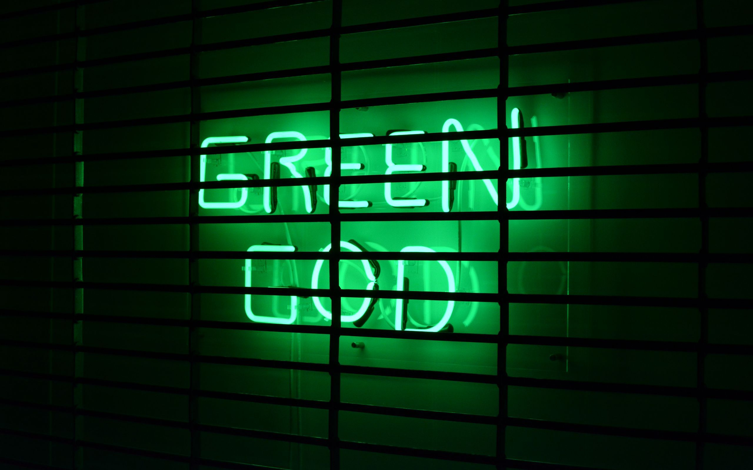 A neon sign in green that reads 