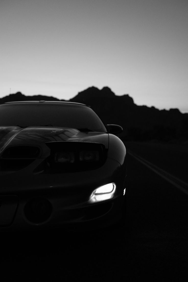 A black and white photo of an automobile - Cars