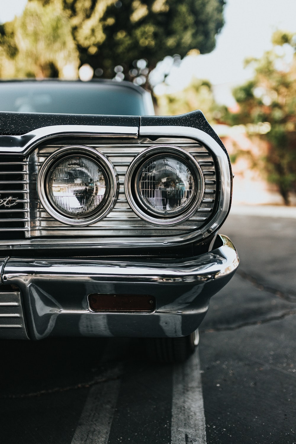 A close up of the headlights of a classic car - Cars