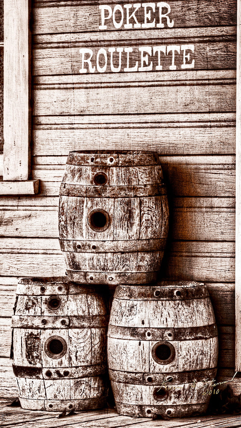 Three wooden barrels with metal rings on the side - Western