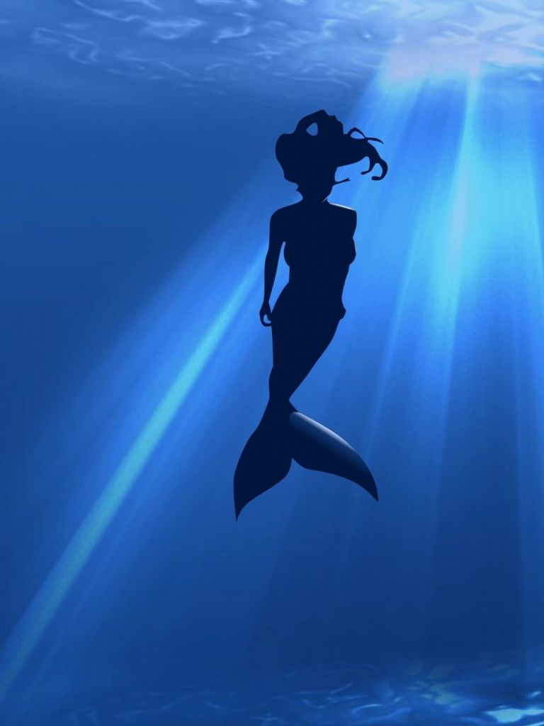 A silhouette of a mermaid swimming in the ocean - Mermaid
