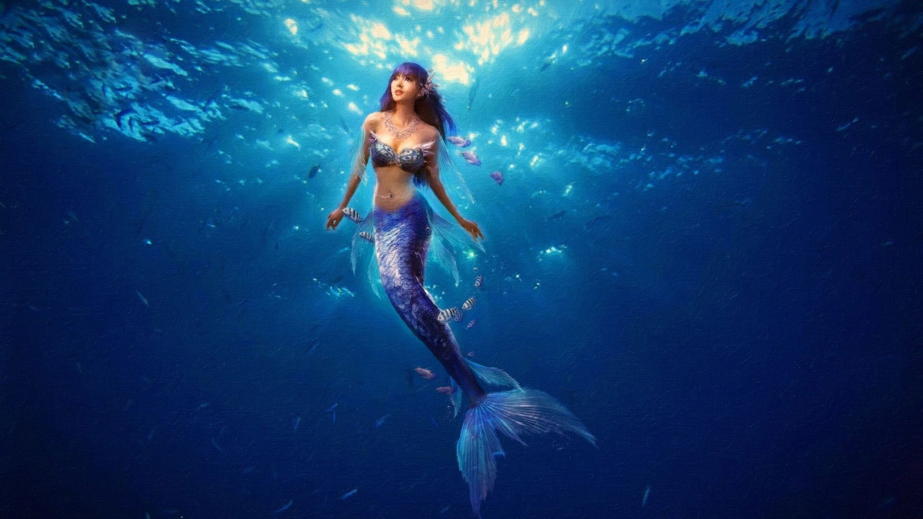 A mermaid in the ocean with fish swimming around her - Mermaid, underwater