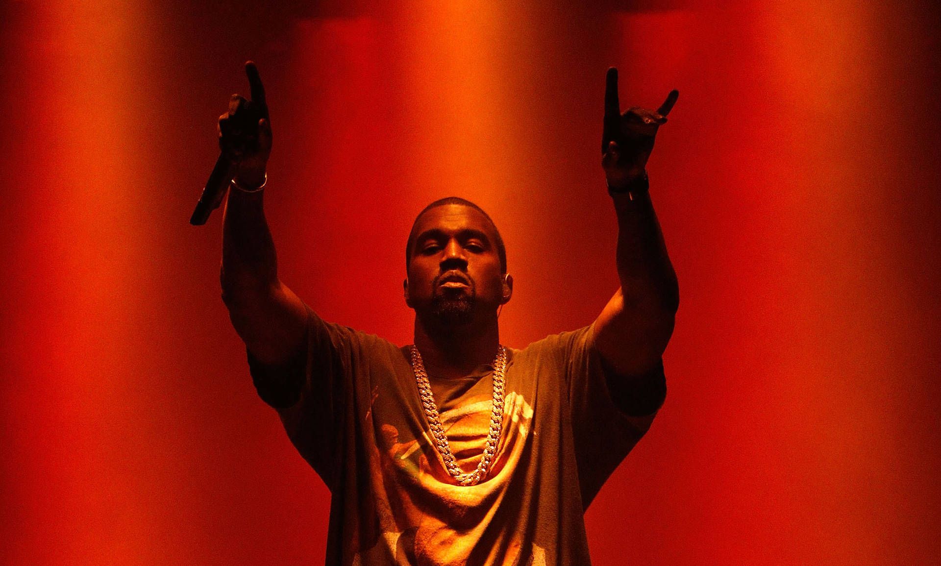 A man holding up his hands in the air - Kanye West