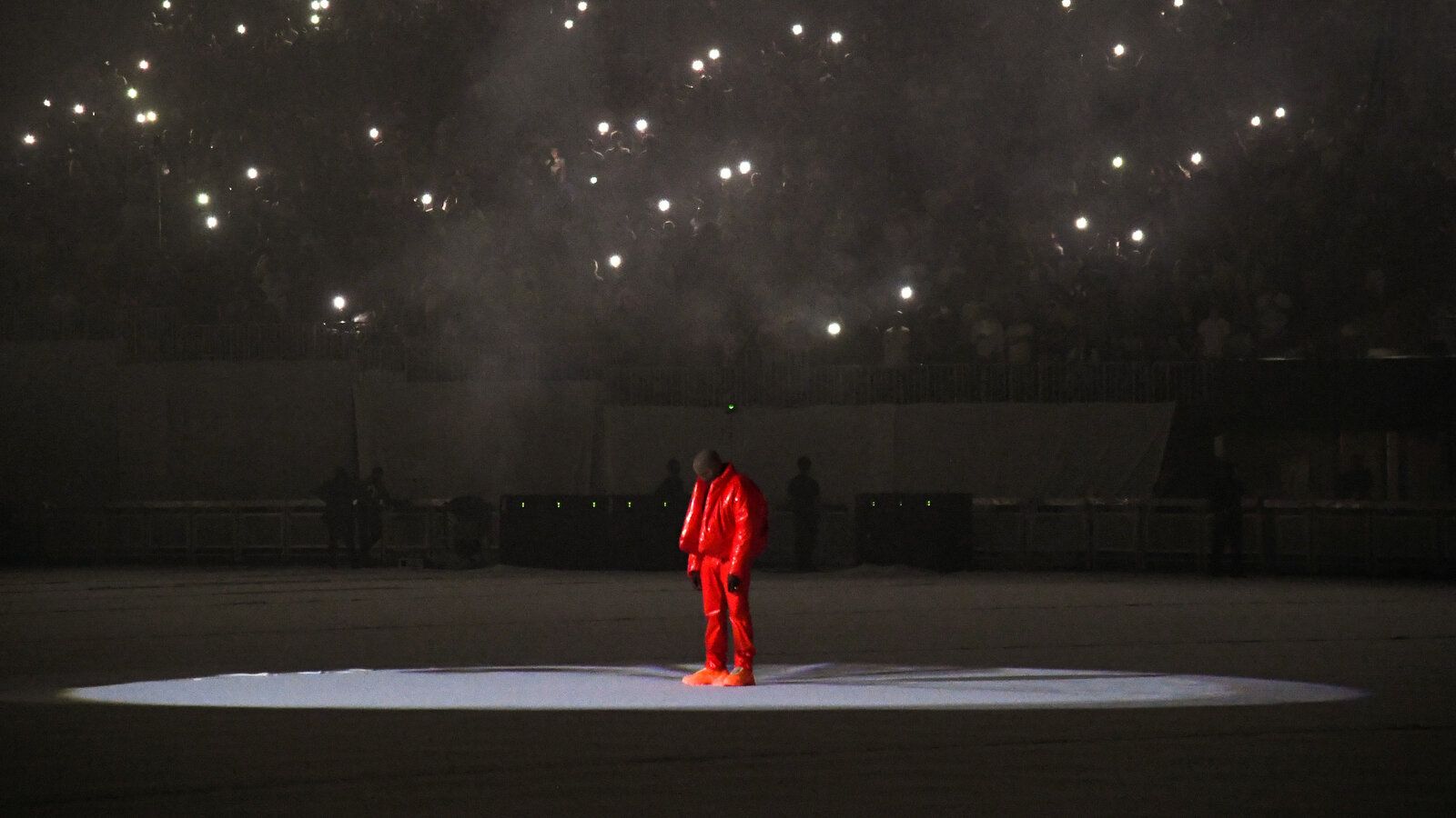 Kanye West performs at the 2015 Nobel Peace Prize Concert in Oslo, Norway, wearing a red tracksuit. - Kanye West