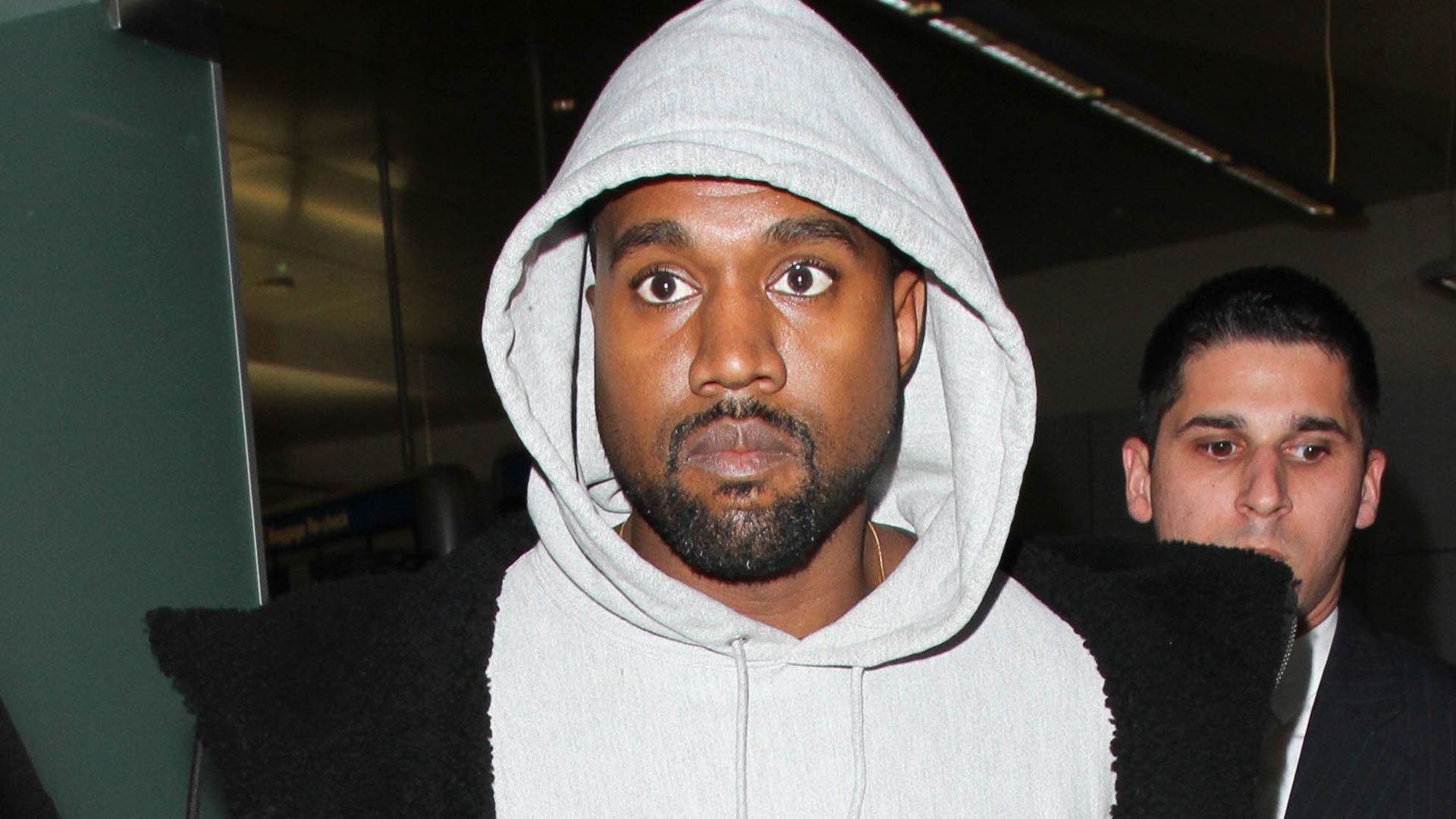 Kanye West wearing a hoodie and a black jacket - Kanye West