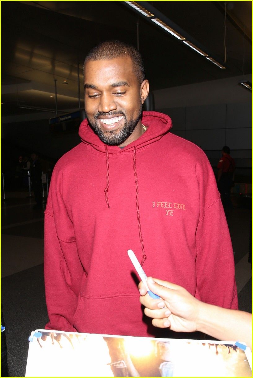 Kanye West signs autographs for fans at the airport - Kanye West