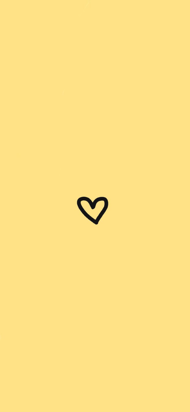 A heart drawn on yellow background - Light yellow