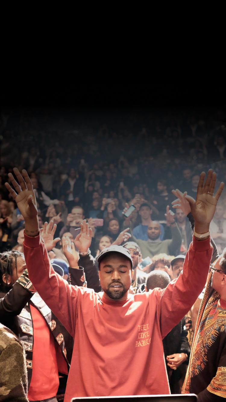 A man in red shirt with hands up - Kanye West