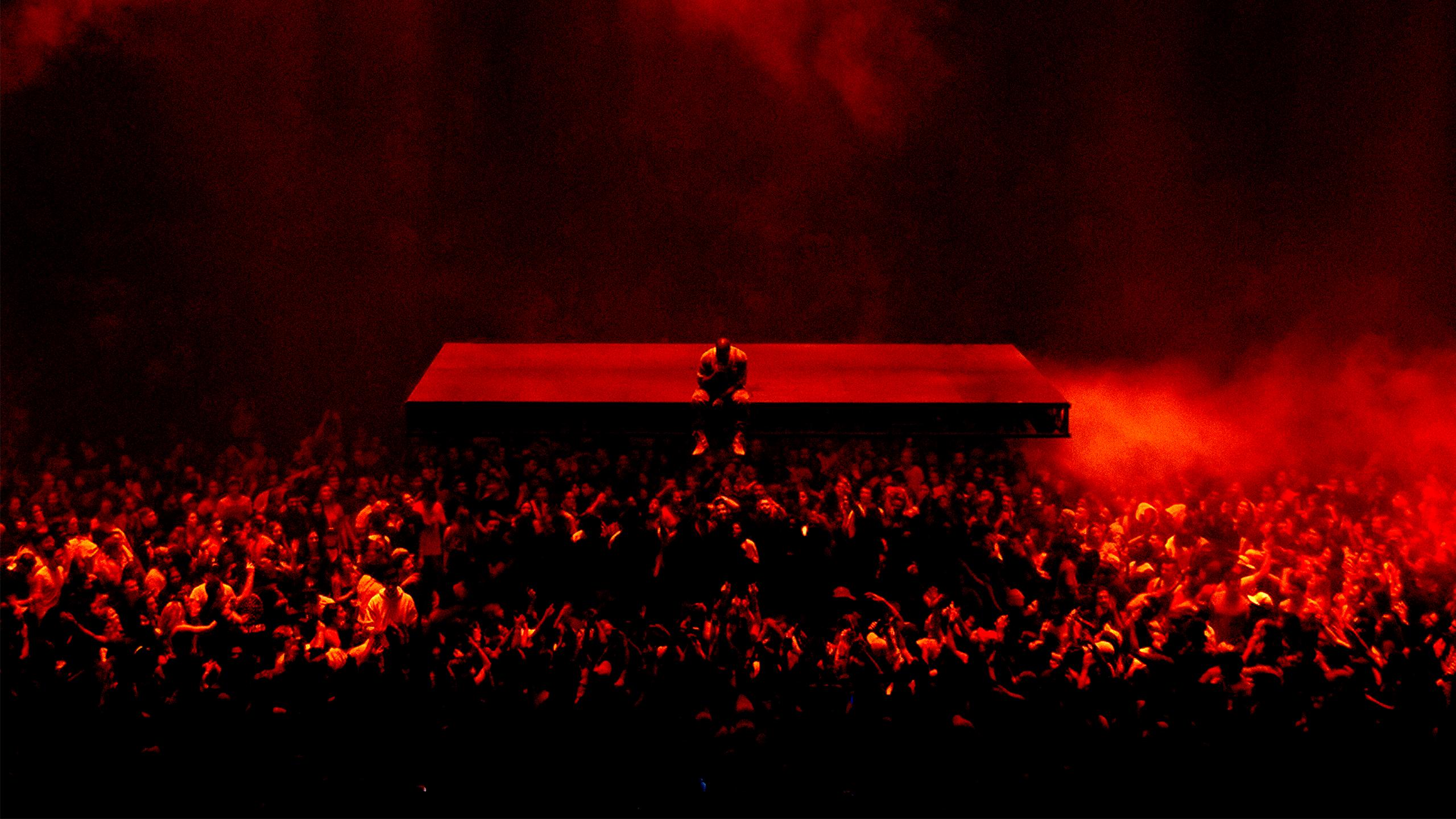 A person standing on top of something in the dark - Kanye West